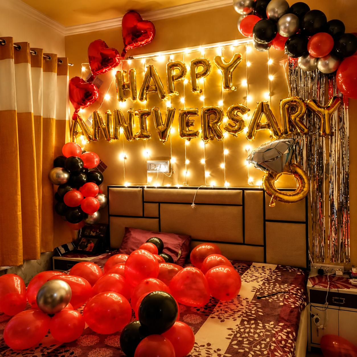 Decorated room with 'Happy Anniversary' balloons and lights on a wall.