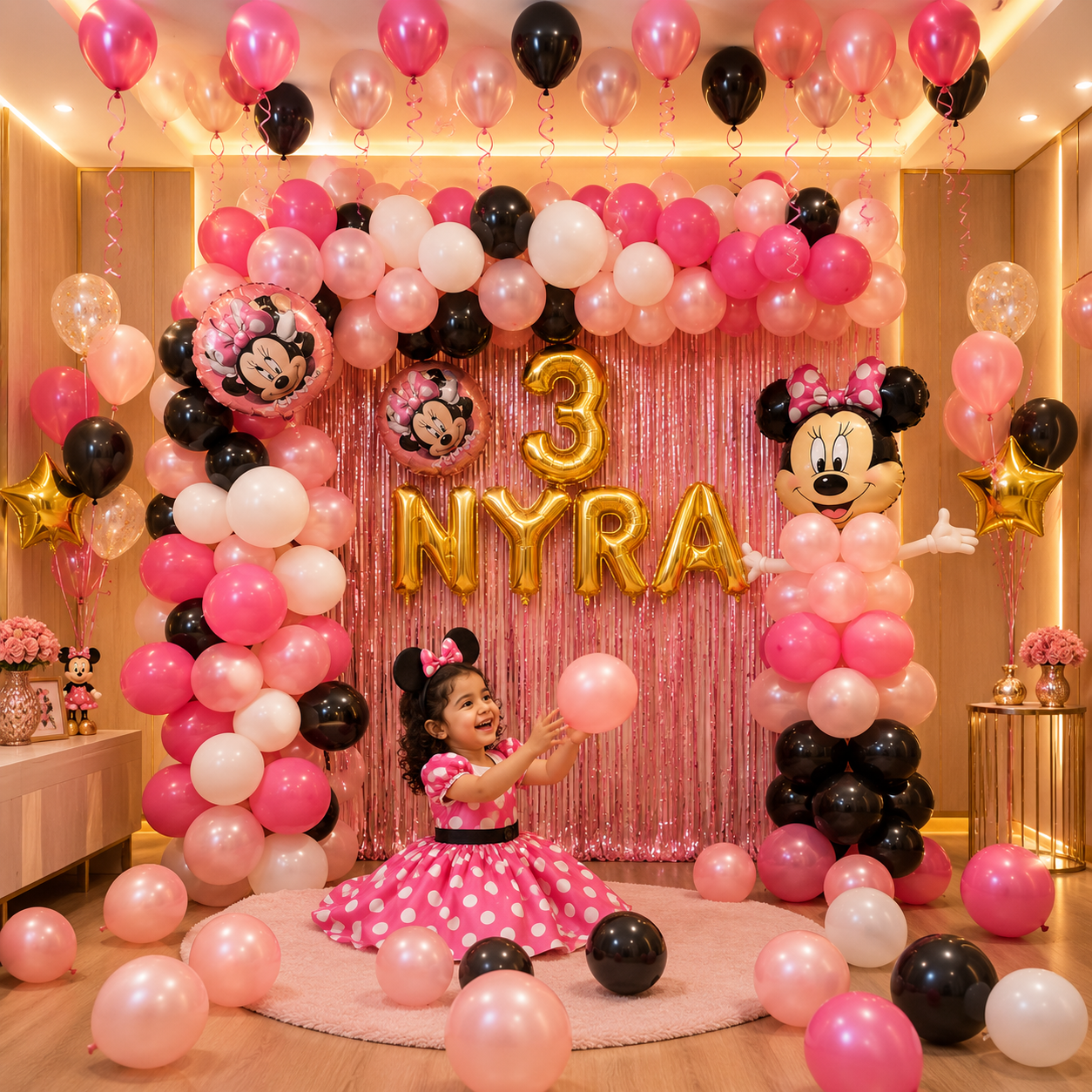 Child in a pink polka dot dress surrounded by Minnie Mouse balloons and decorations with '3 NYRA' in gold letters.