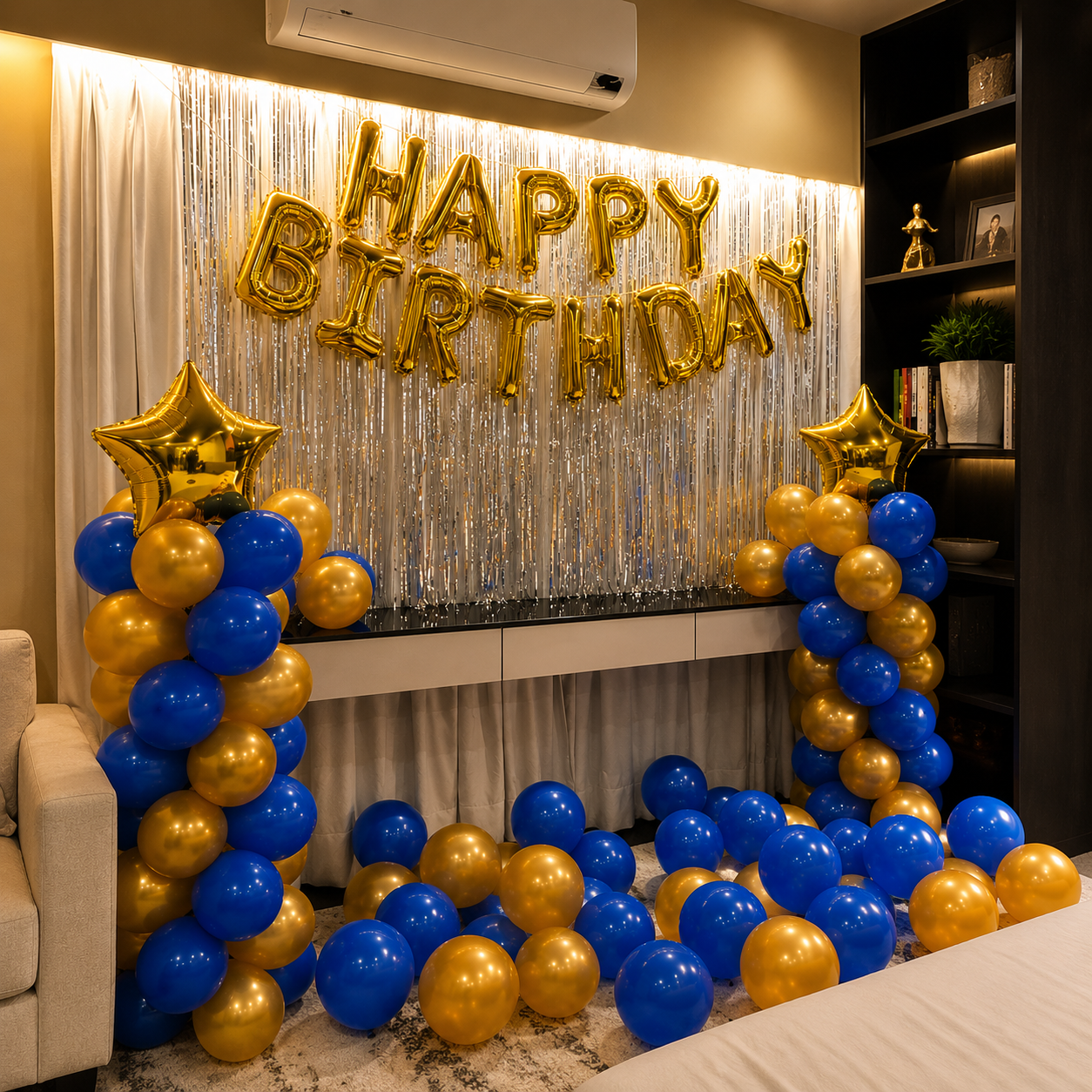 Birthday celebration setup with gold, blue, and star balloons against a 'Happy Birthday' sign.