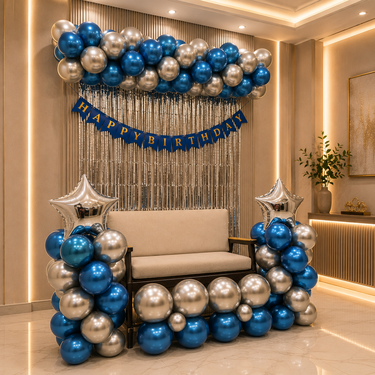 Birthday decoration with blue, silver, and gold balloons in a room.