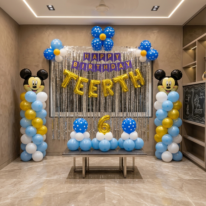 Birthday celebration setup with balloons and decorations in a room.