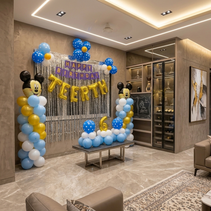 Birthday decoration with balloons and arch in a living room.