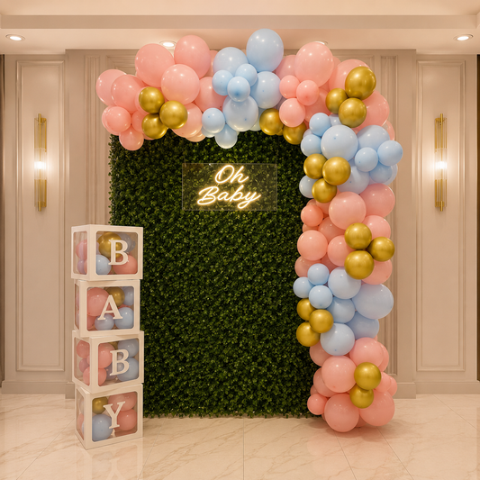 Balloon arch with 'Oh Baby' sign and baby blocks in a decorated room.