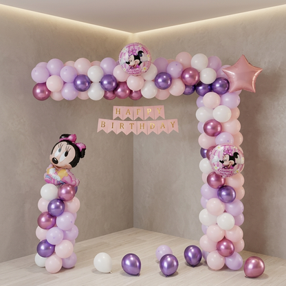 Balloon arch with Minnie Mouse decorations and 'Happy Birthday' banner on a neutral background