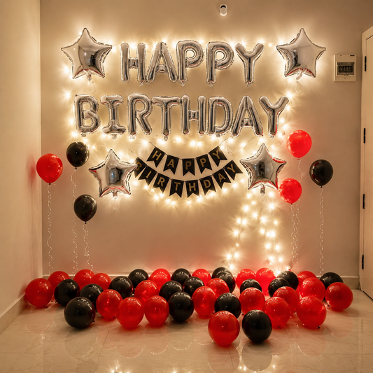 Birthday decoration with balloons and lights on a floor.
