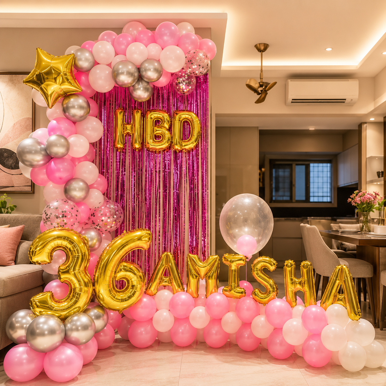 Birthday decoration with balloons and 'HBD 36 Amisha' text in a room.