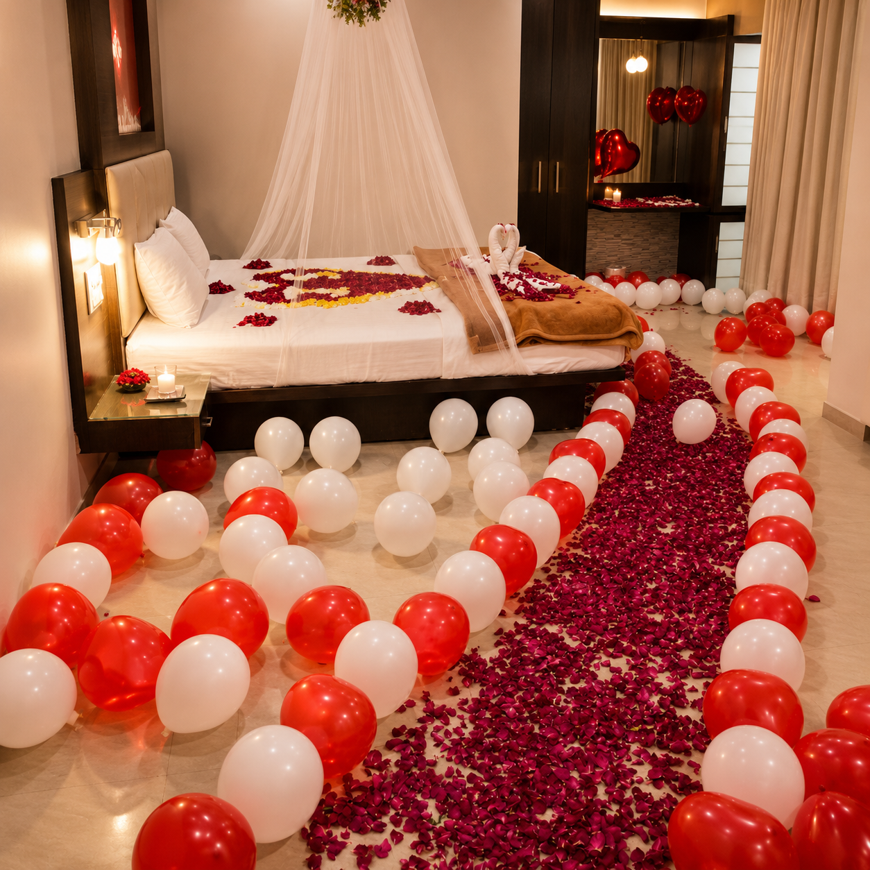 Decorative setup with red and white balloons, rose petals, and a heart shape on a bed.