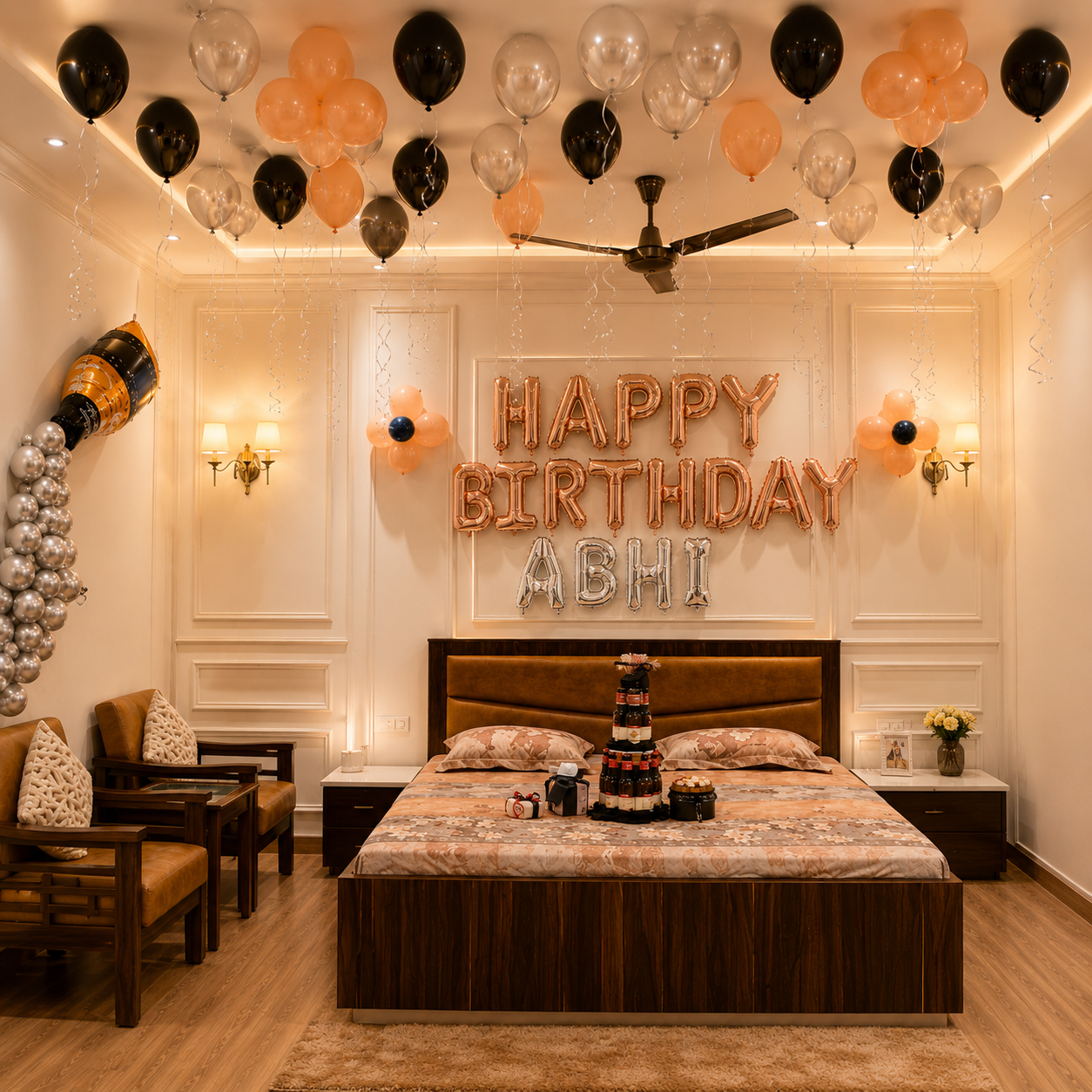 Decorated bedroom with 'Happy Birthday Abhi' rose gold balloons, cake, and balloons on the ceiling.