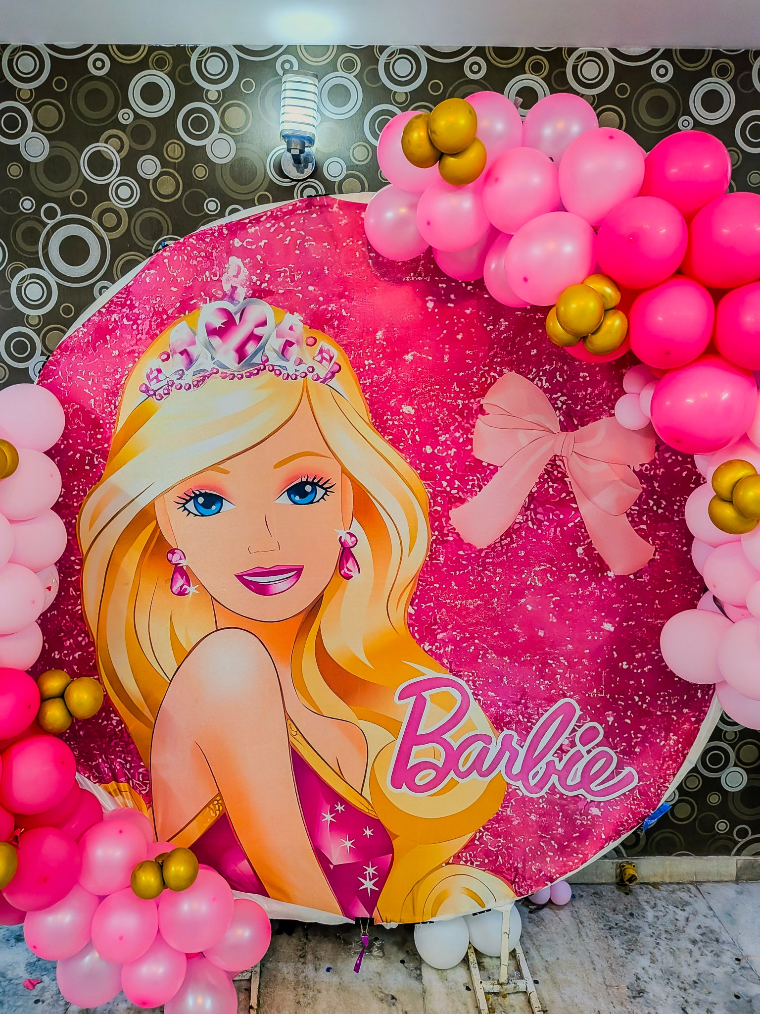 Barbie-themed balloon arch with pink and gold balloons