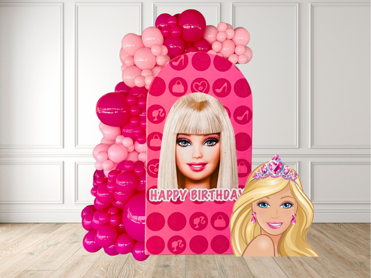 Barbie-themed birthday balloon arch with pink and red balloons against a white wall.