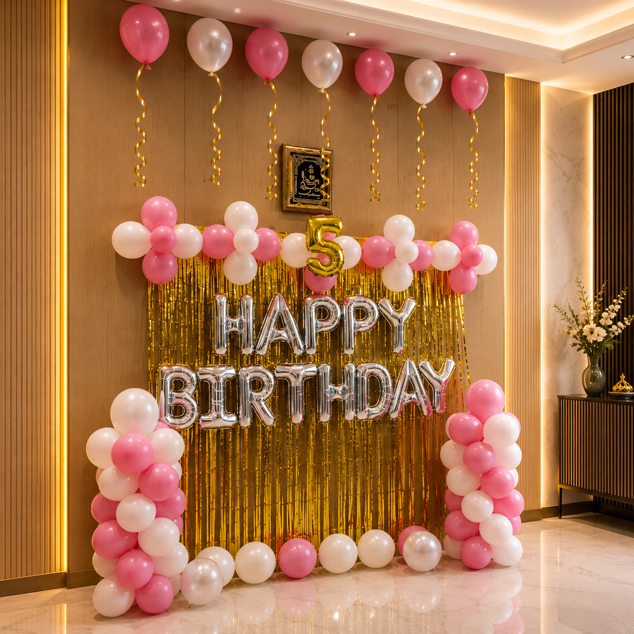 Birthday decoration with balloons and 'Happy Birthday' sign in a room.