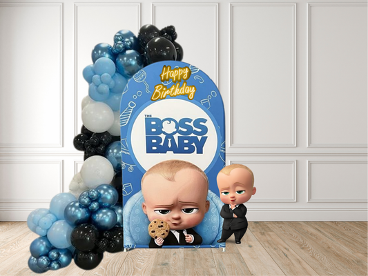 Birthday banner with 'The Boss Baby' characters and balloons on a wooden floor.