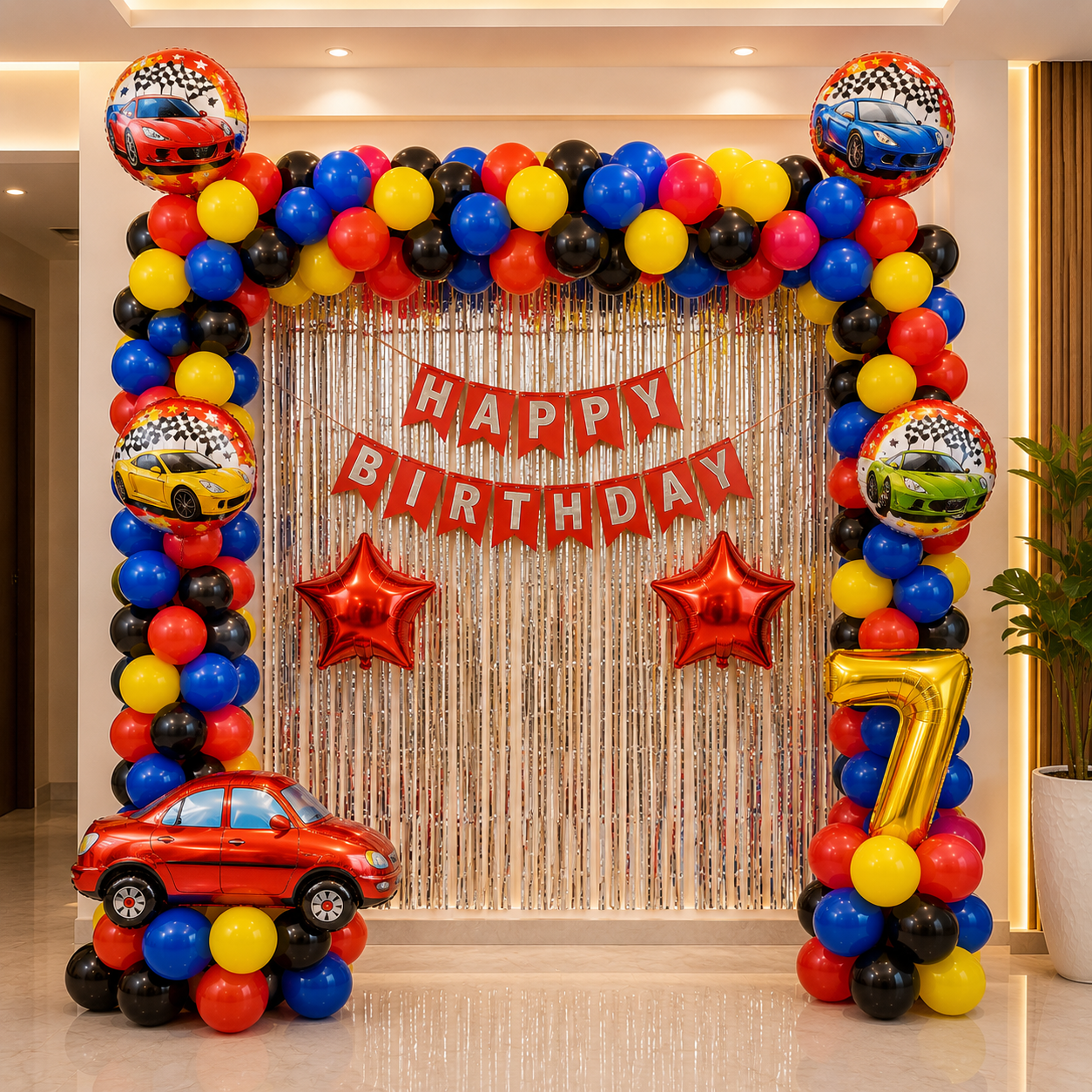 Birthday party setup with colorful balloons, car-themed balloons, and a 'Happy Birthday' banner.