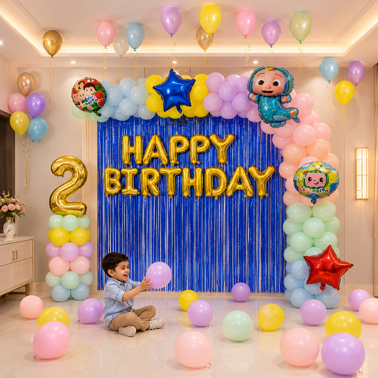 Child celebrating a 2nd birthday with colorful balloons and decorations.