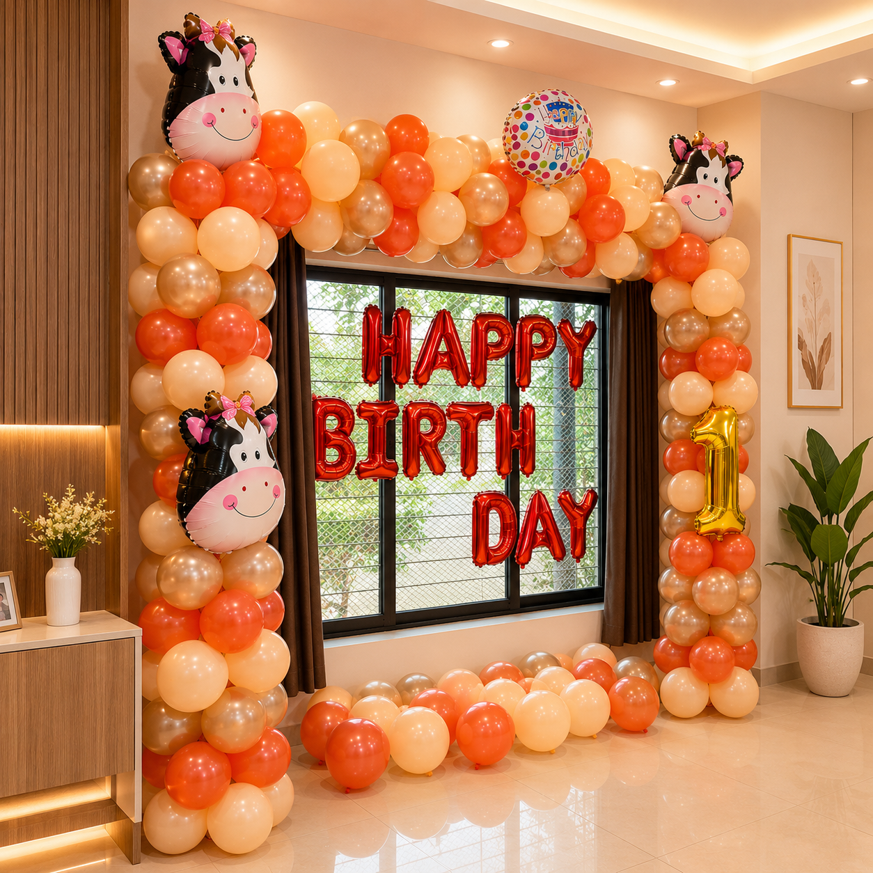 Birthday balloon arch with 'Happy Birthday' and number '1' balloons in a room.