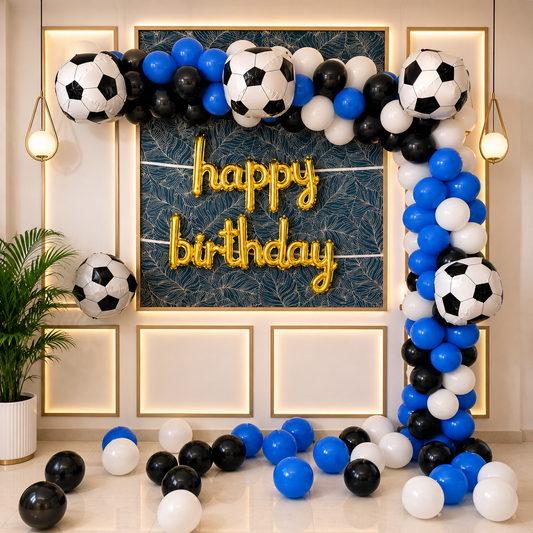 Birthday decoration with soccer balls, balloons, and 'happy birthday' sign.