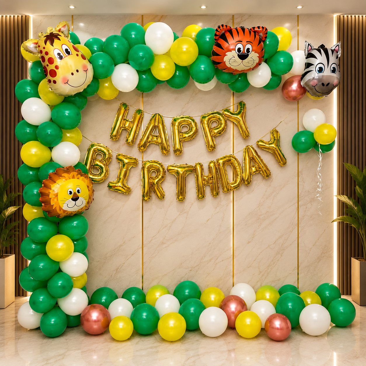 Colorful balloon arch with animal faces and 'Happy Birthday' balloons on a wooden wall.
