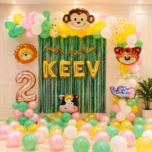 Birthday party setup with colorful balloons, animal-themed decorations, and 'Happy Birthday KEEV' banner.
