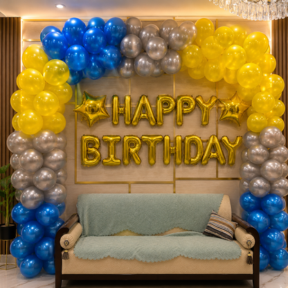 Birthday decoration with balloons and 'Happy Birthday' sign in a room.
