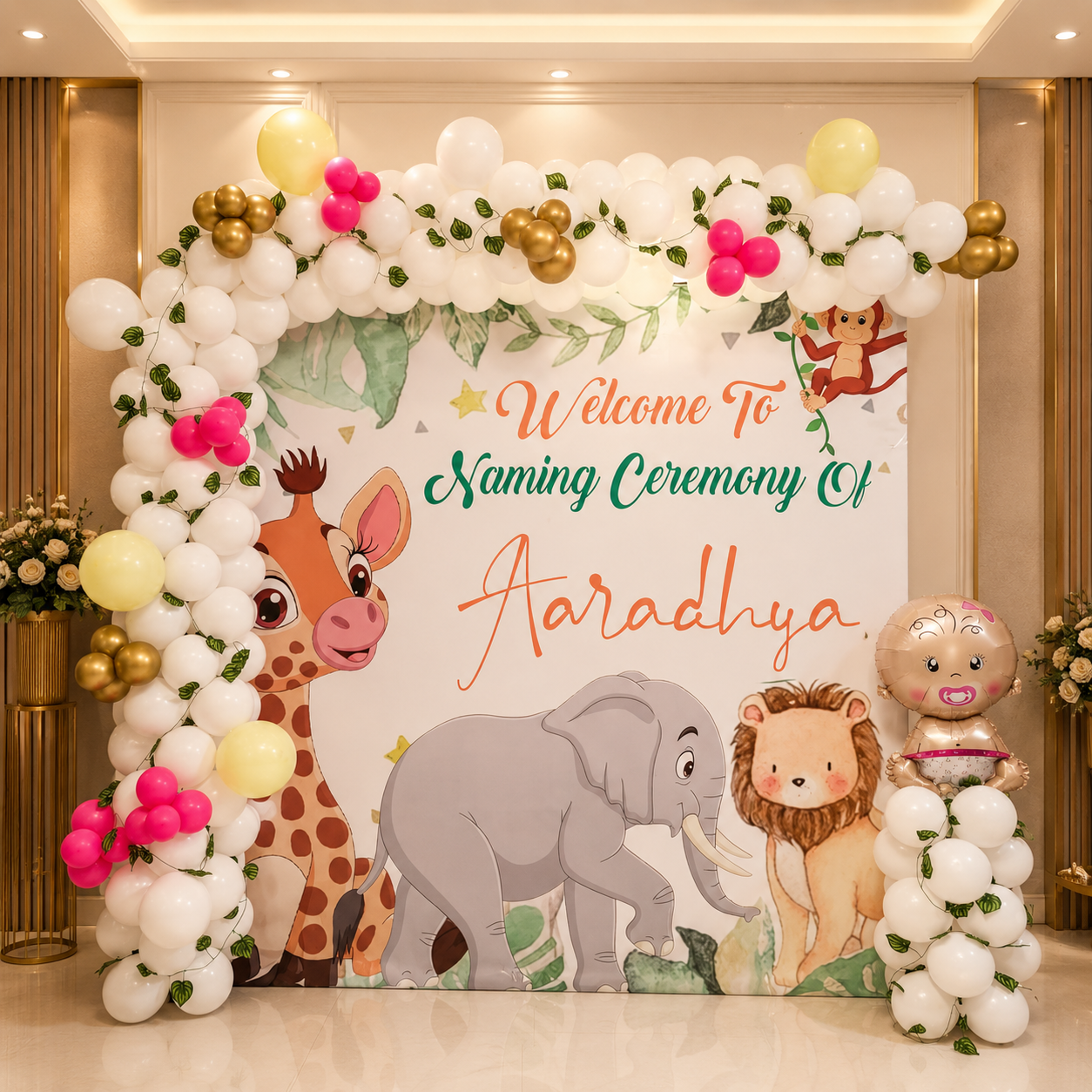 Decorative arch with balloons and cartoon animals for a naming ceremony.