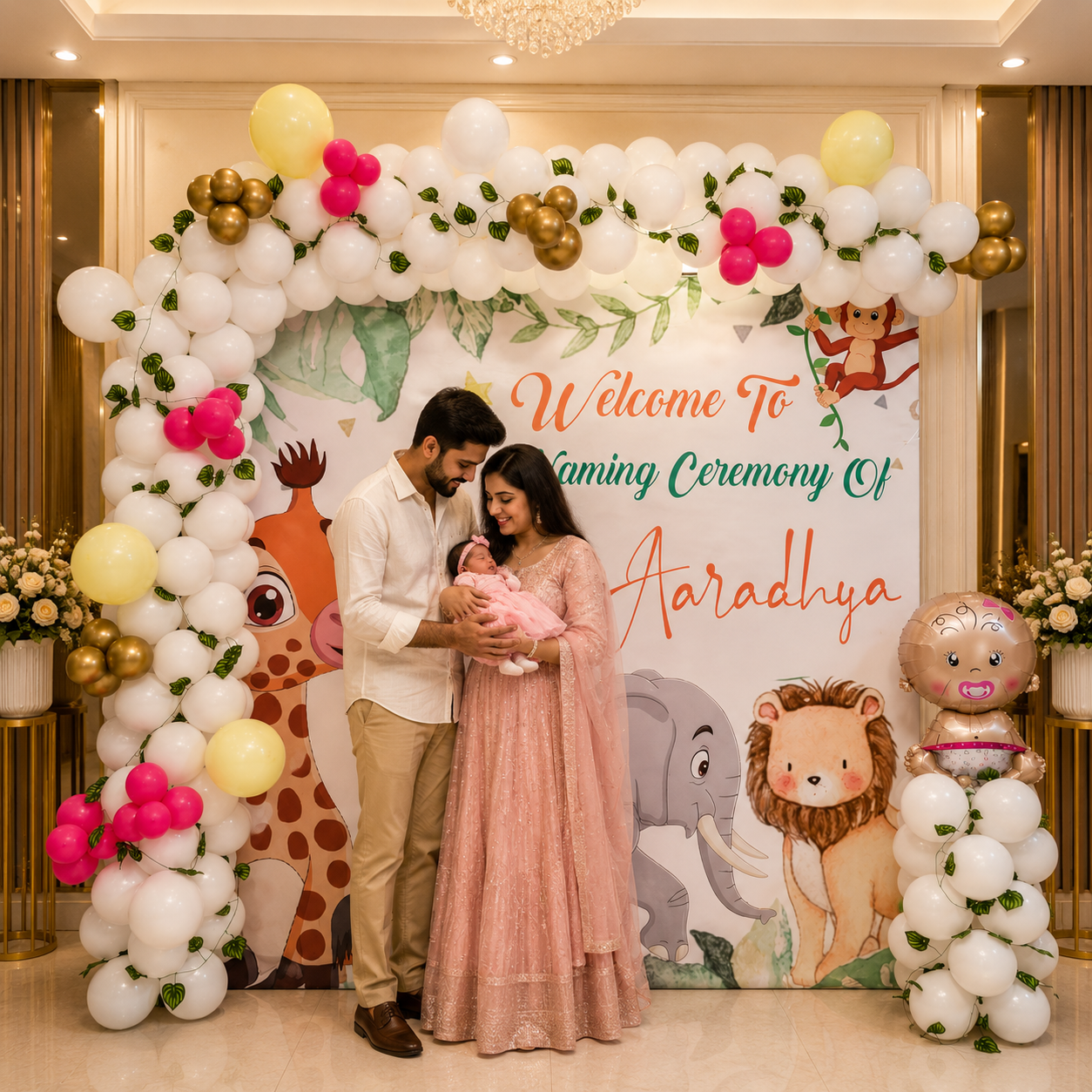 Family with a baby at a naming ceremony decorated with balloons and animal-themed backdrop