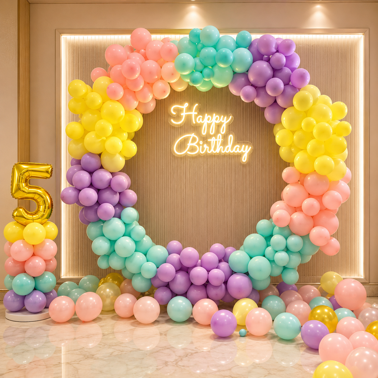 Colorful balloon arch with 'Happy Birthday' and number 5 in a room setting