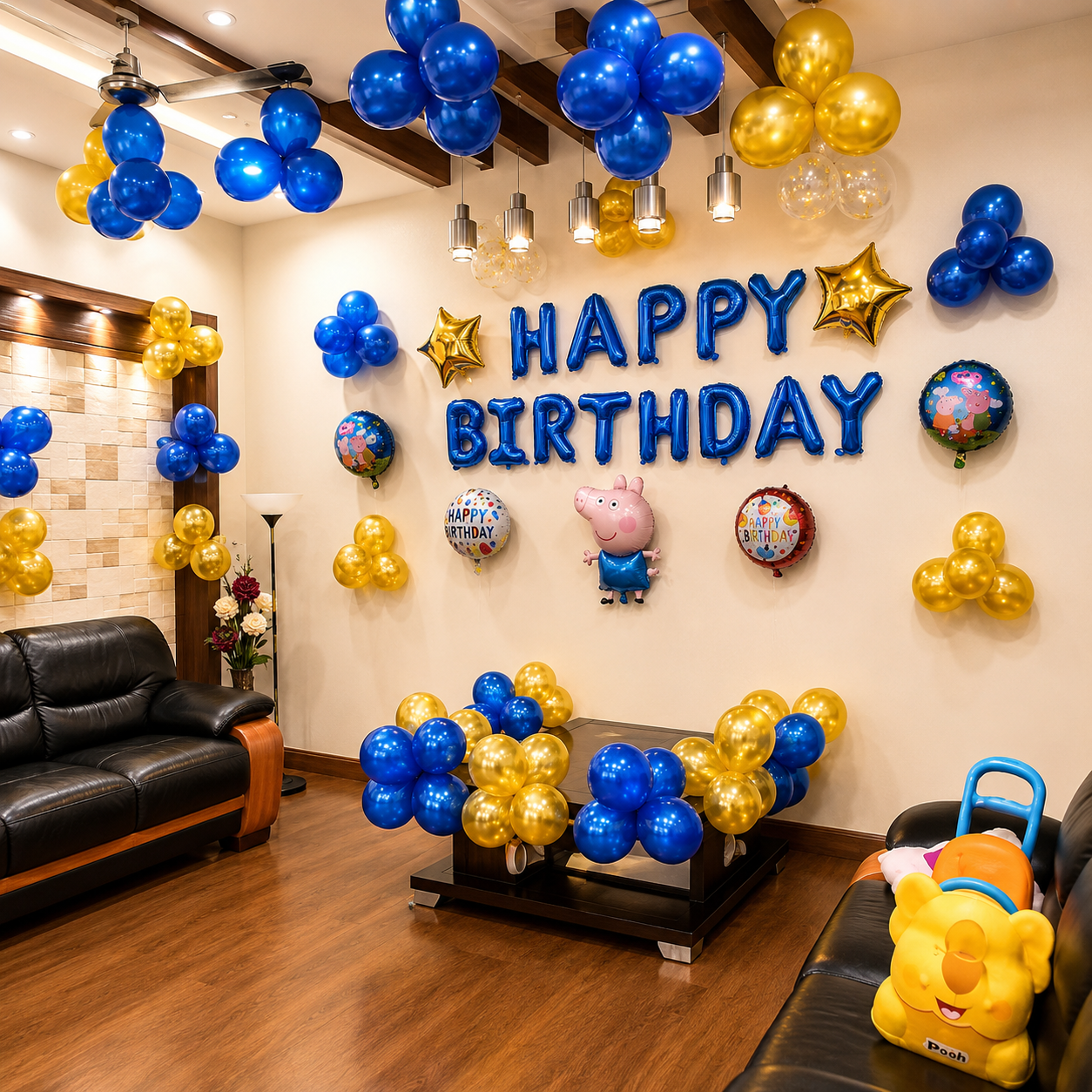Birthday room decoration with blue and gold balloons, 'Happy Birthday' sign, and children's toys.