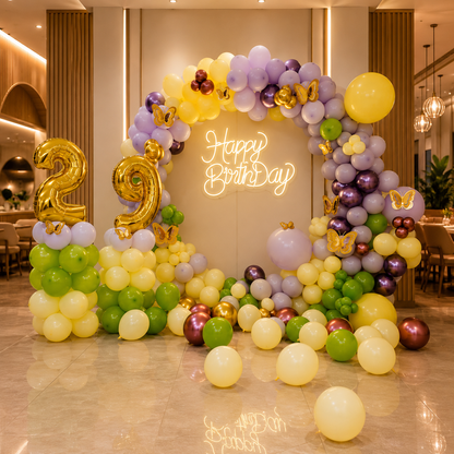 Balloon arch with 'Happy Birthday' and number decorations in a celebratory setting.