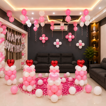 Living room decorated with pink, white, and red balloons for a birthday celebration.