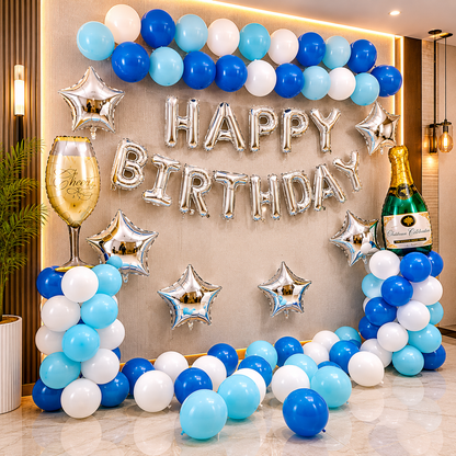 Birthday celebration setup with balloons, 'Happy Birthday' banner, and champagne bottle decorations.