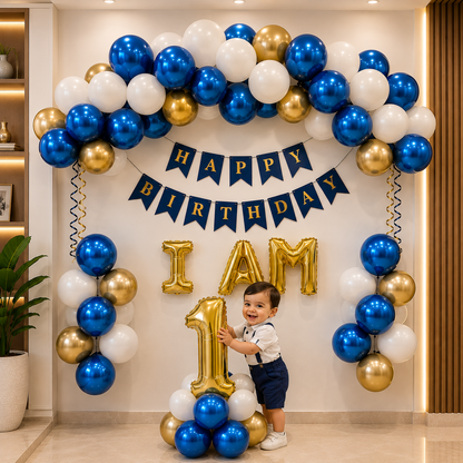 Child standing in front of a birthday balloon arch with 'Happy Birthday' and 'I am 1' decorations.