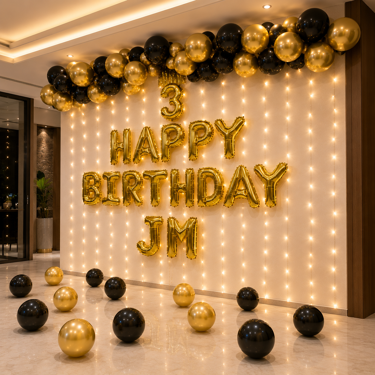 Decorative setup with balloons and lights for a birthday celebration, featuring '3 Happy Birthday JM' text.