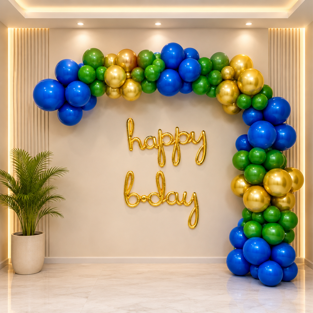 Balloon arch with blue, green, and gold balloons and 'happy birthday' sign on a beige wall.