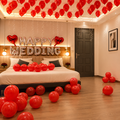 Decorated bedroom with red balloons and 'Happy Wedding' sign.