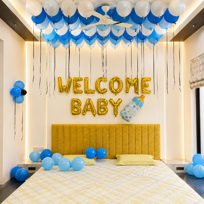 Decorated room with blue and white balloons, 'Welcome Baby' sign, and yellow headboard.