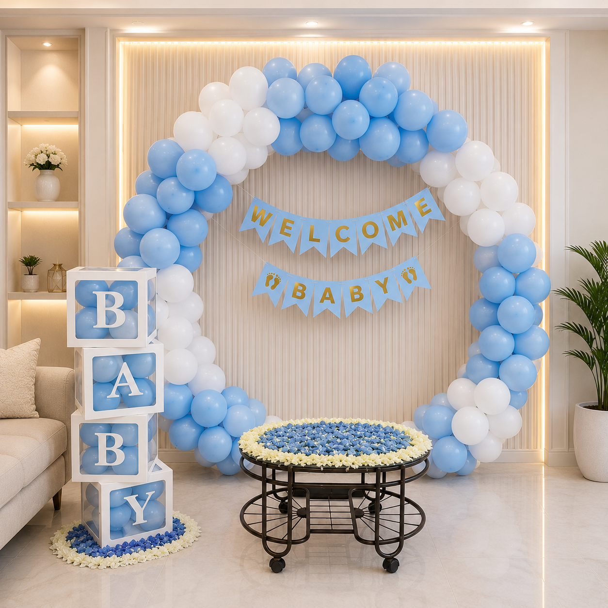 Decorative setup with balloons, baby blocks, and a banner in a room.